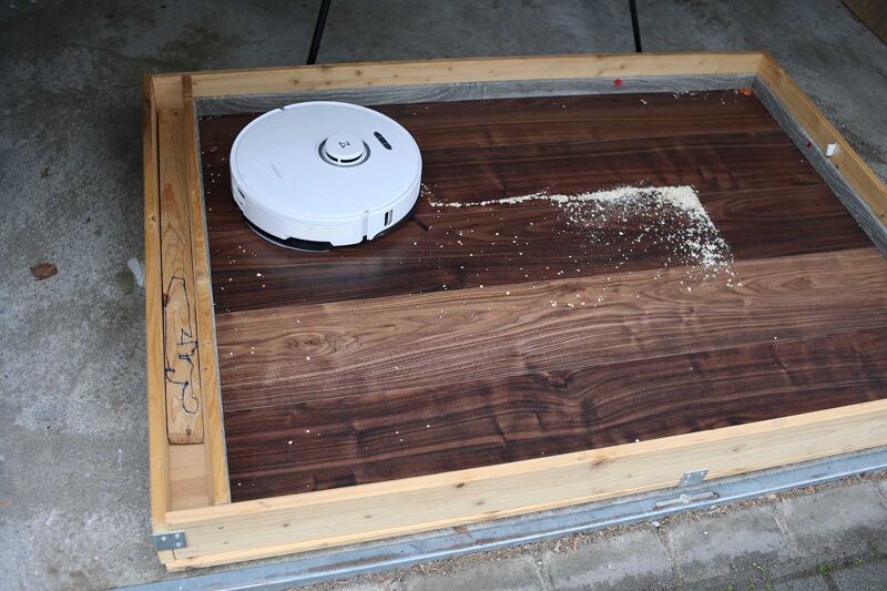 Vacuuming oat flakes on hard floor